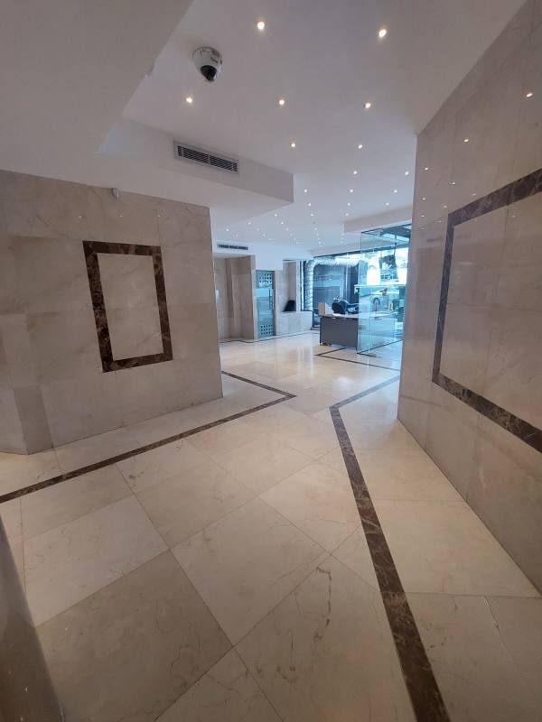 Empty office with drop ceiling, glass block window, fluorescent lighting in Obarrio Panama