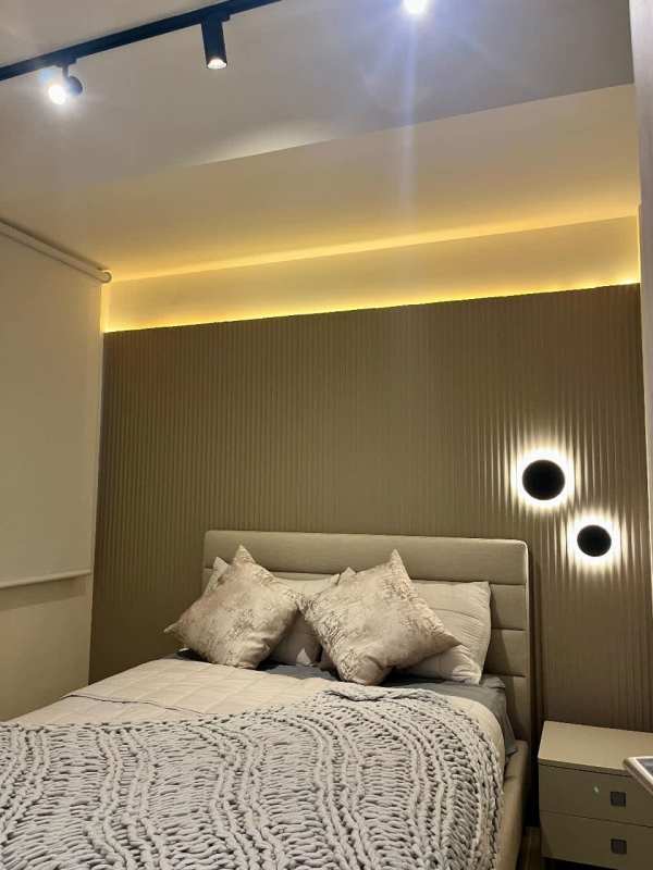 Contemporary bathroom with marble counters and glass shower in Santa María luxury apartment