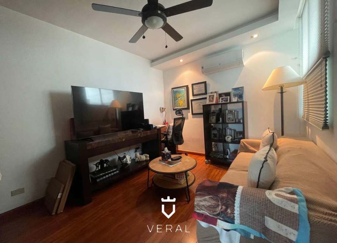 Modern bedroom with large ocean view window, ceiling fan and minimalist decor at PH Veranda Tower Panama City