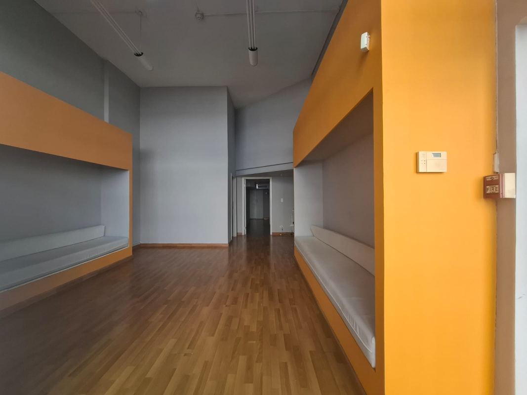 Lobby space with high ceiling, built-in seating and wood flooring in commercial plaza San Francisco Panama City