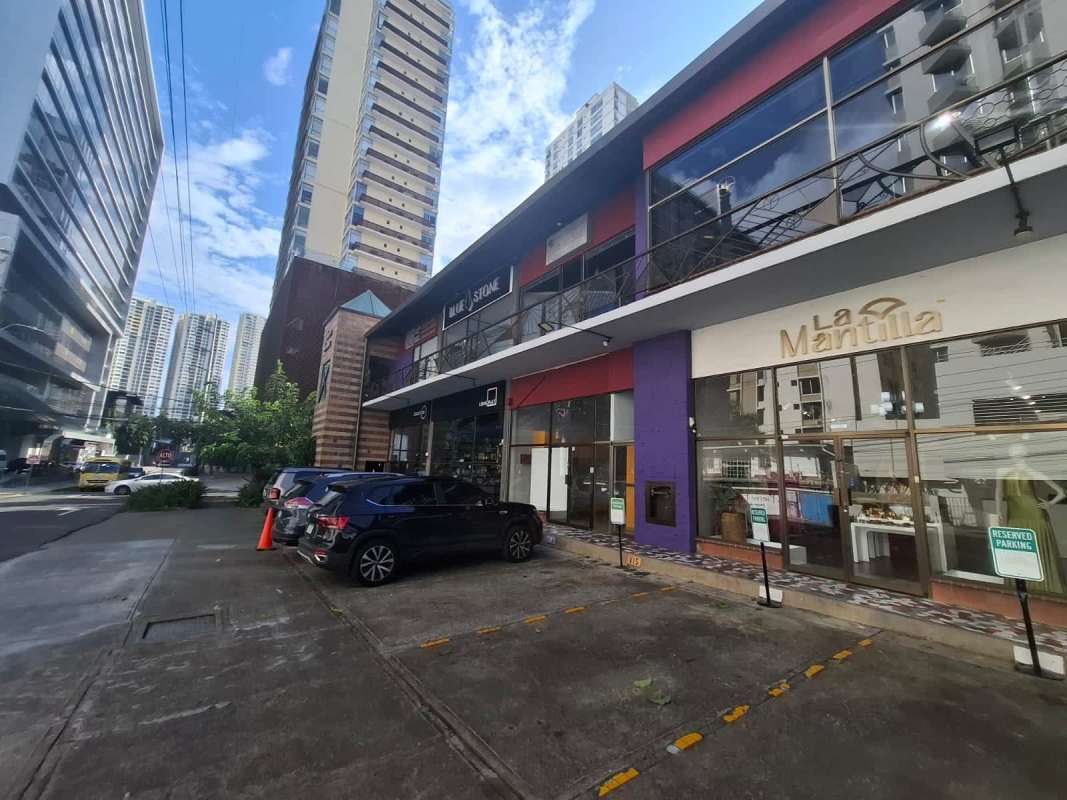 Glass fronted commercial plaza exterior with parking at Calle 76 Este San Francisco Panama City