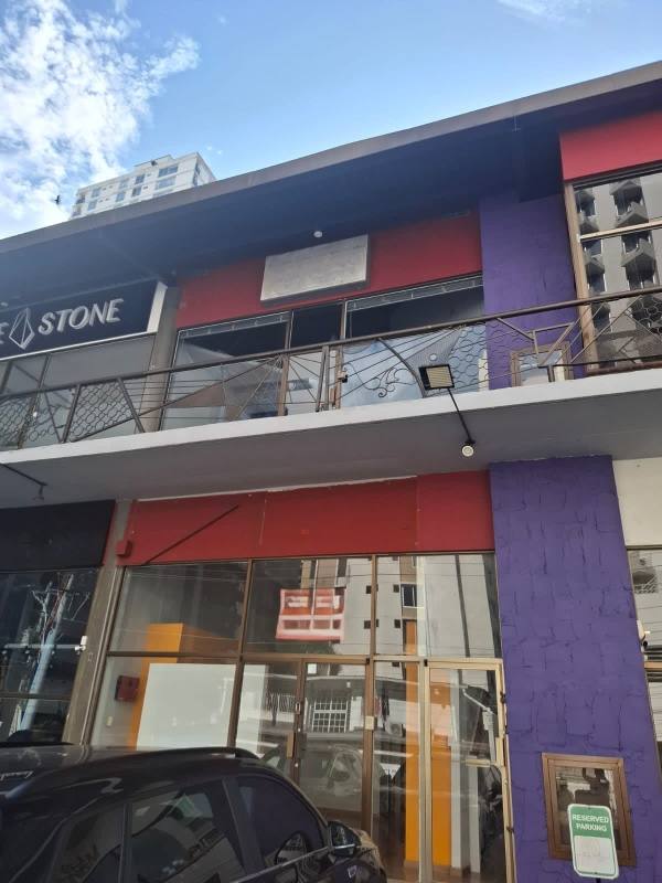 Two-story modern commercial building with glass storefronts and balconies on Calle 76 Este, San Francisco Panama