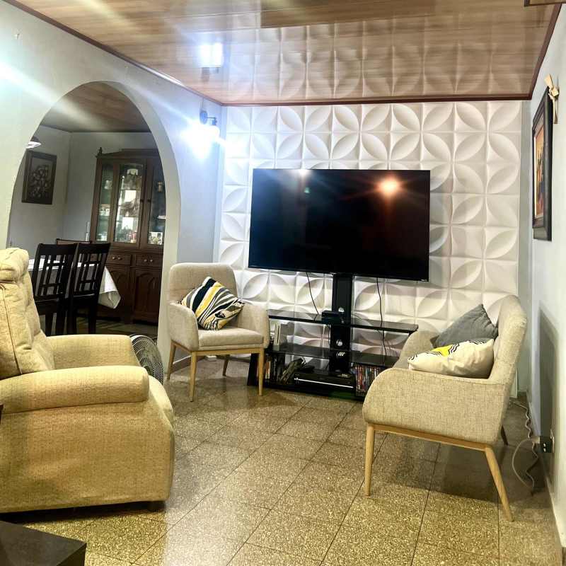 Classic white kitchen with dining table, gas stove, cabinetry in Cerro Viento house