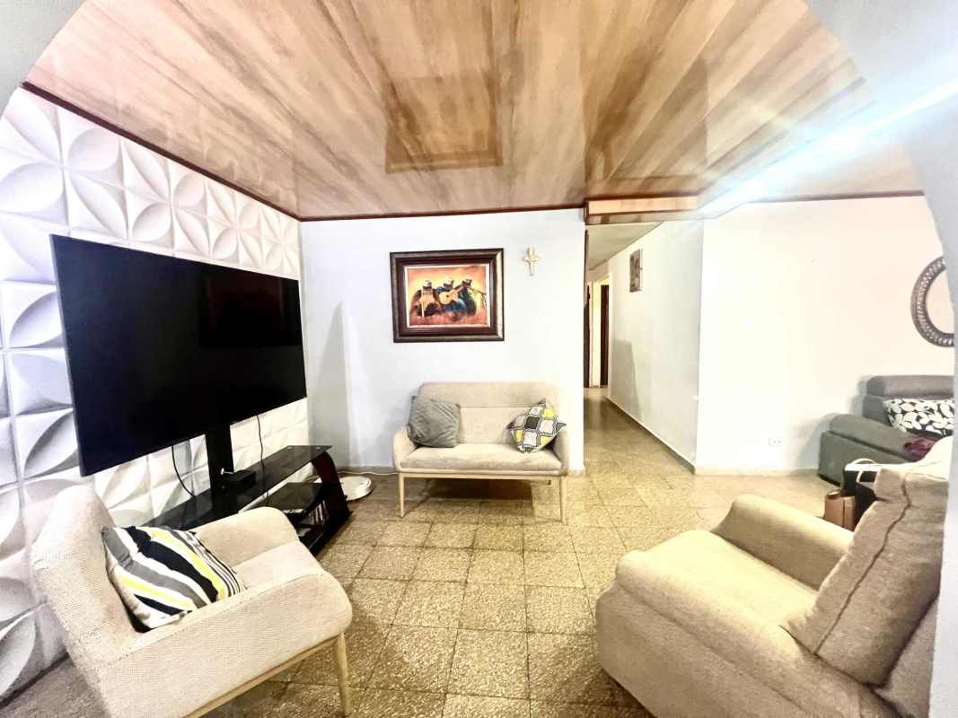 Living room with textured accent wall, flat screen TV, armchairs and recliner in Cerro Viento Panama