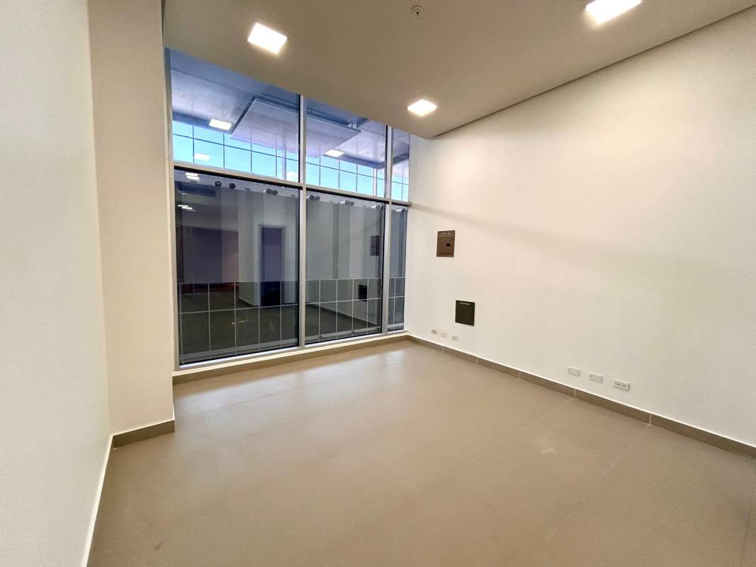 Modern office unit with large floor to ceiling glass window and neutral floors Costa del Este