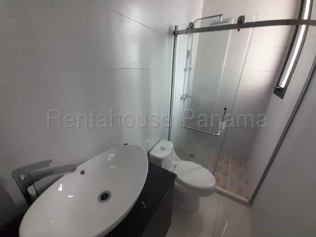 Contemporary kitchen with granite countertops, island and wooden cabinets at PH Carreras in Panama