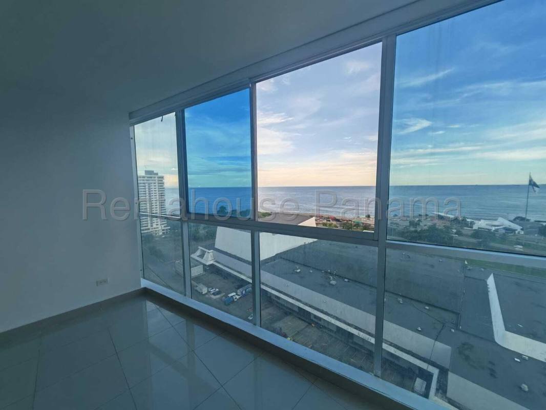 Spacious living room area with panoramic ocean views in PH Serenity