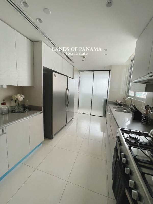 Bright master bedroom at PH Costanera Bella Vista with large windows and city view