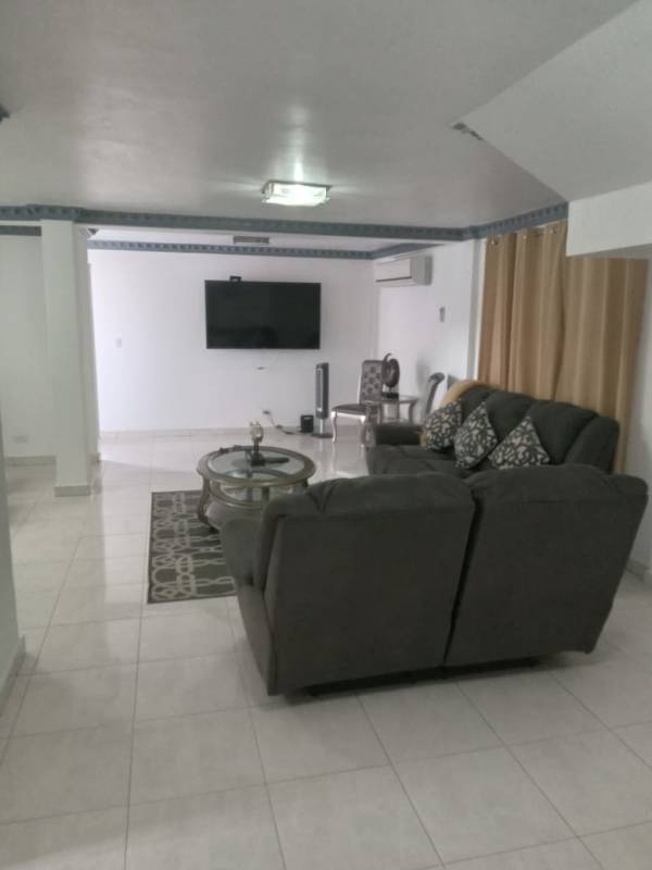 Contemporary living room with sectional sofa air conditioning and TV in spacious rental house Condado del Rey Panama
