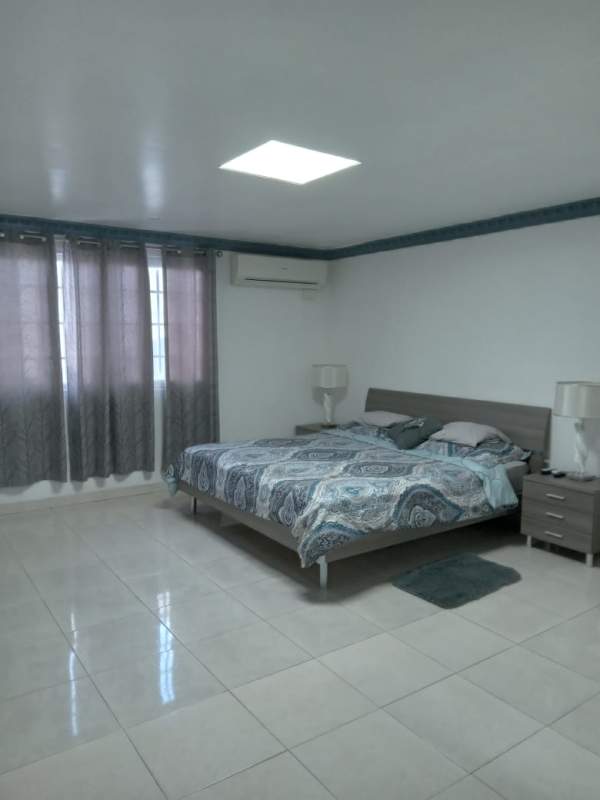 Bedroom with large bed split AC closet renting house Altos de Santa María Panama
