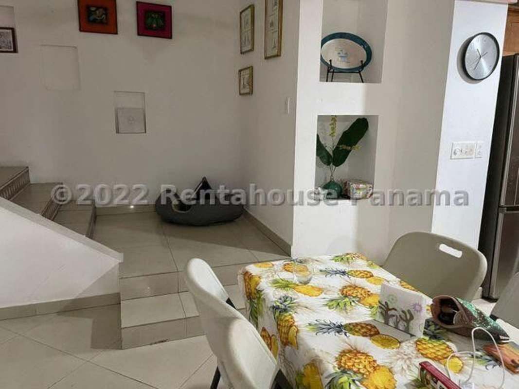 Living room with tile floors, glass door, decorative wall, connected to terrace in Panama City house