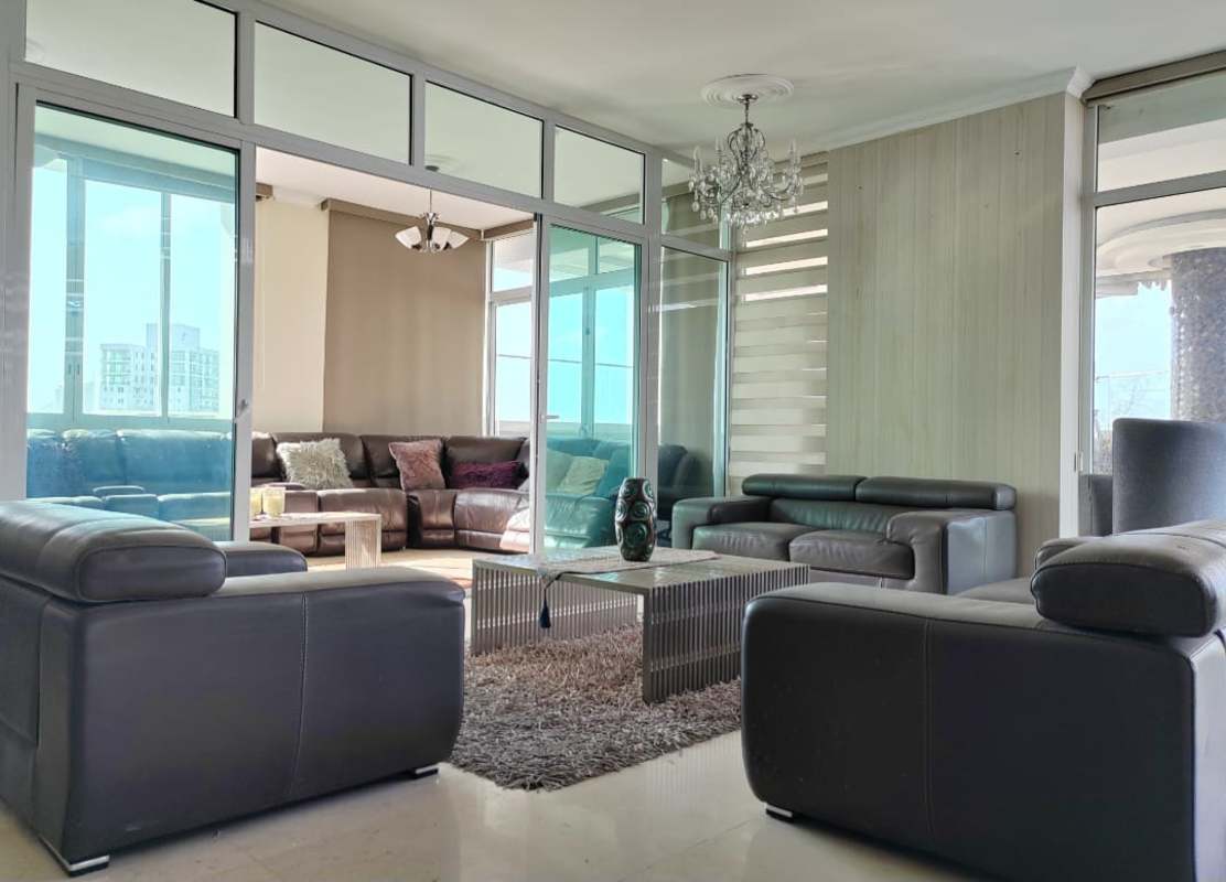 Large living room with floor-to-ceiling windows panoramic views Highland View Panama