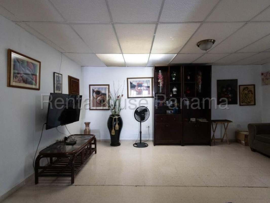 Entertainment room with tiled floor, wood cabinetry and ceiling details in Villa Lucre
