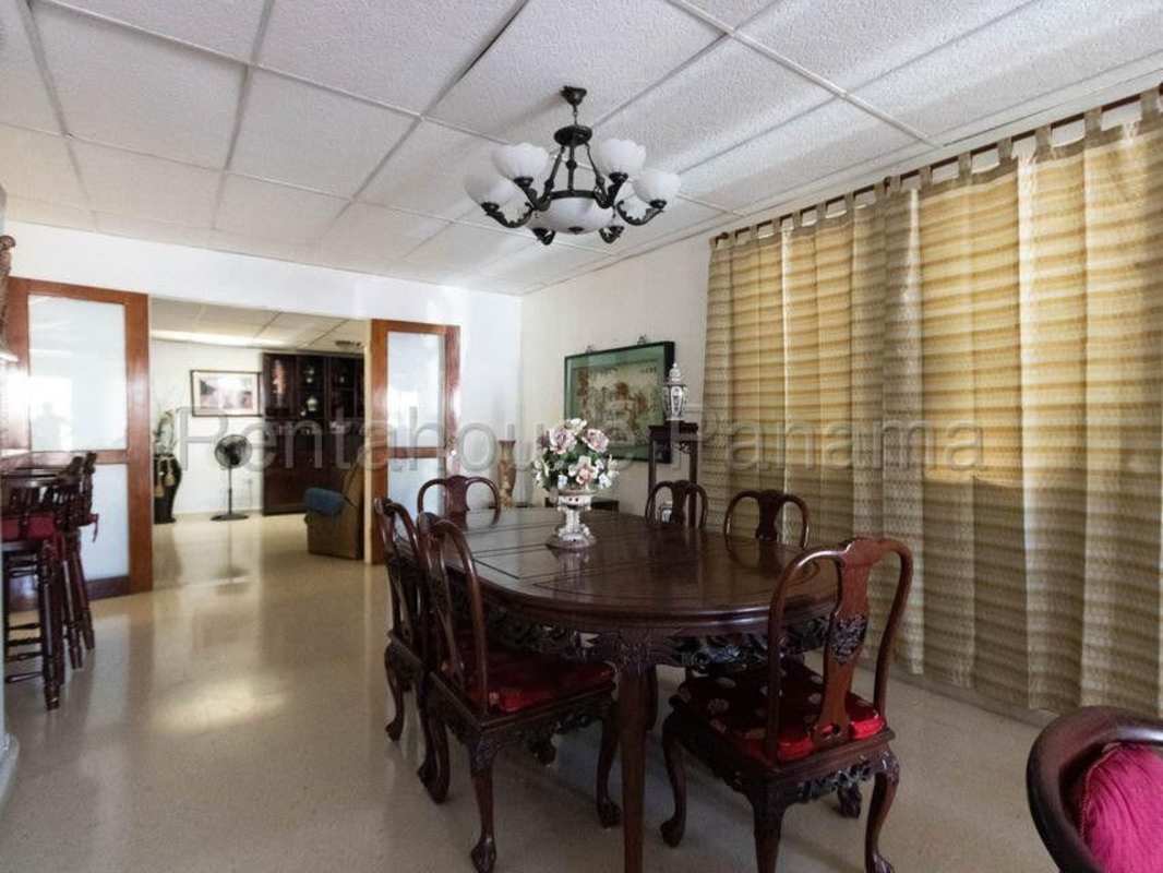 Bright living room with tiled floor and traditional wood furniture in Villa Lucre home Panama