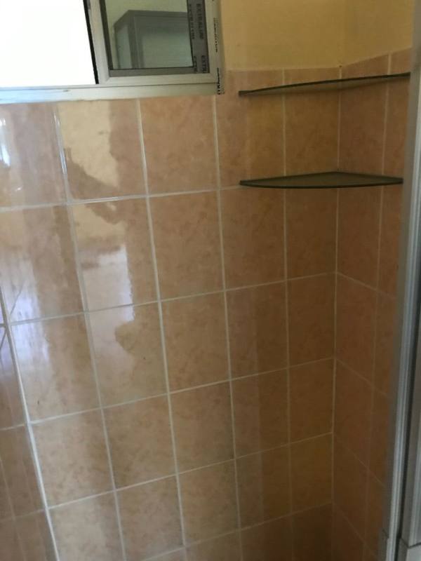 Ceramic tiled bathroom with walk-in shower corner shelves Villa Guadalupe Panama