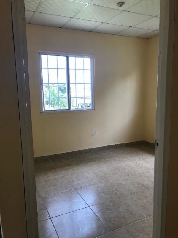 Bright bedroom with ceramic floor and window at house Pedregal Panama