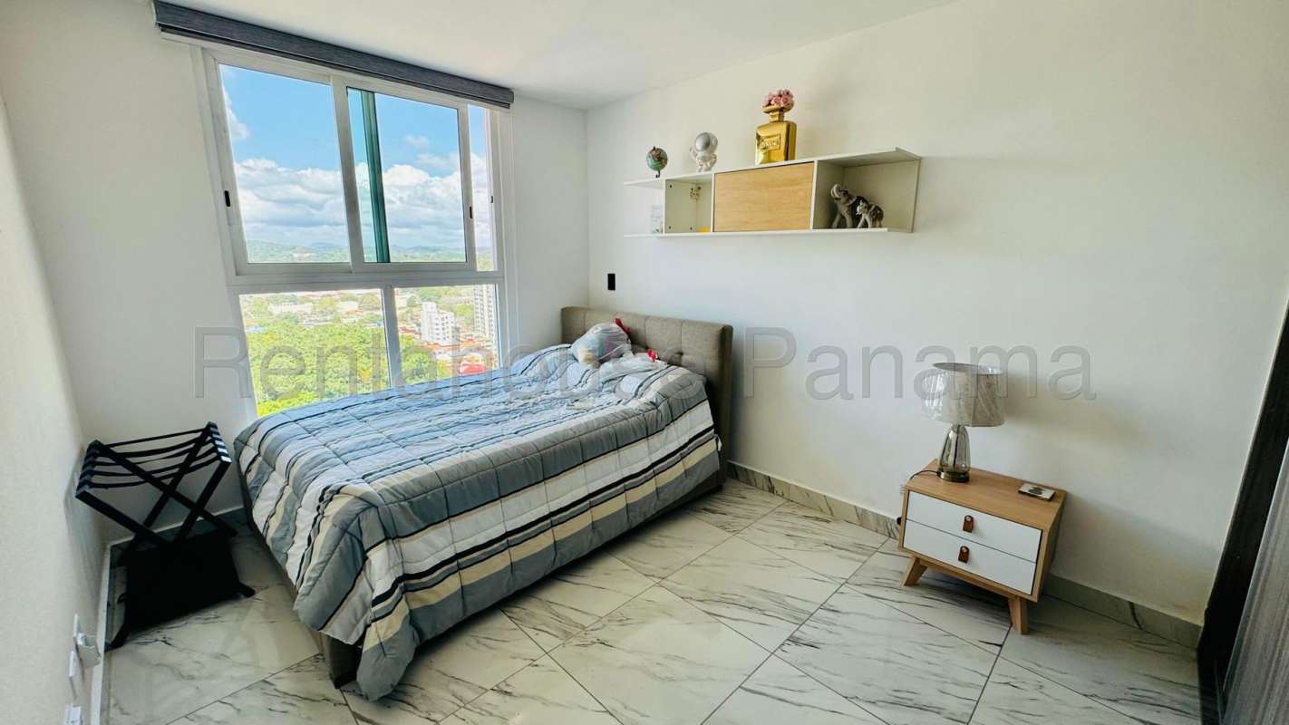 Bedroom with built-in closet, large window, AC and bed at PH Quartz Tower Panama City