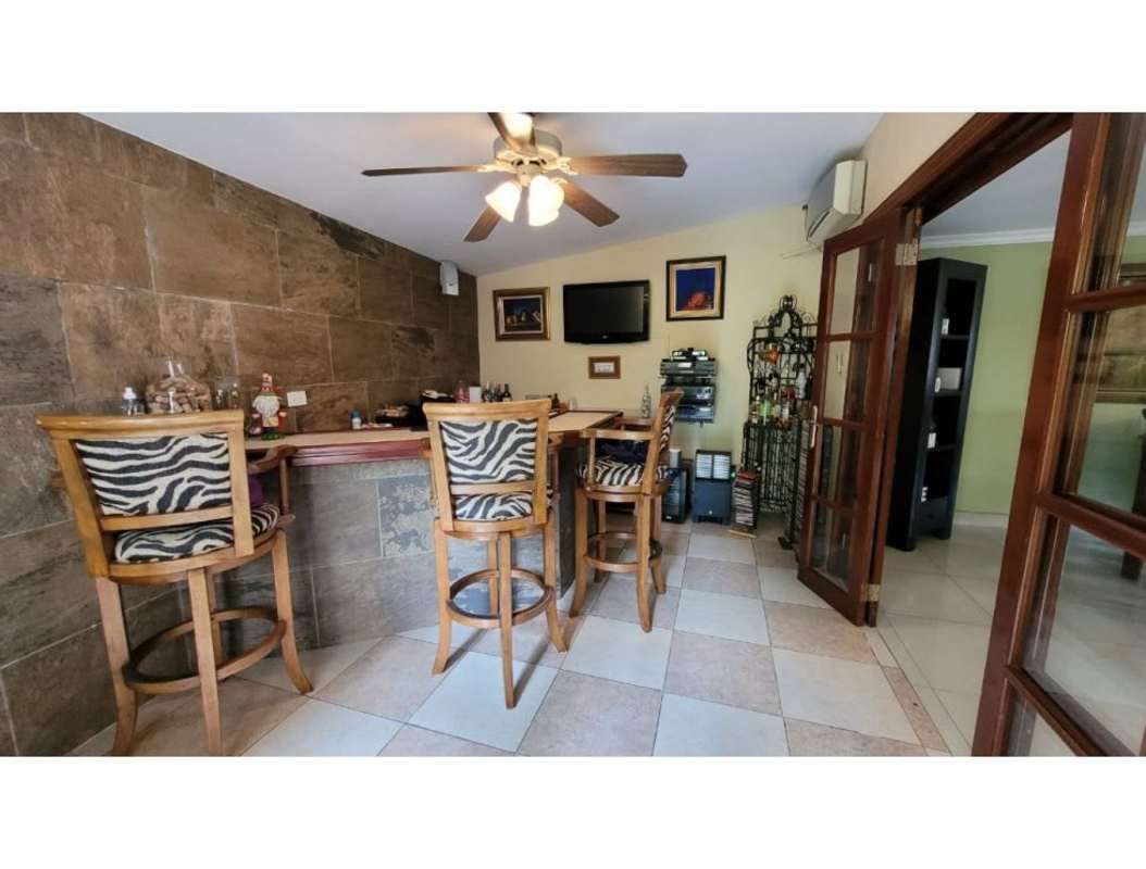 Home entertainment bar with stone accent wall in Altos del Golf Panama residence