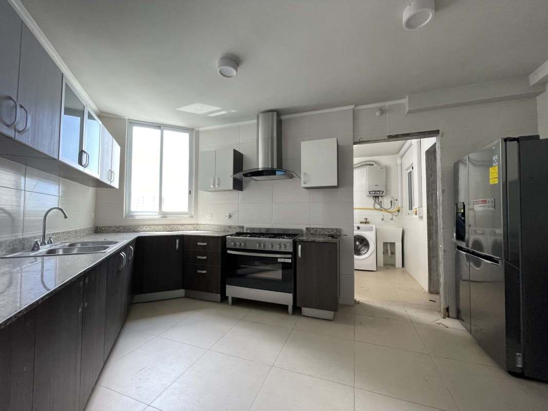 Fully equipped modern kitchen with granite countertops, appliances, window in PH Country Club Costa del Este