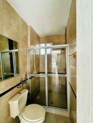 Modern kitchen with granite countertops and hardwood cabinets in beachfront condo Panama