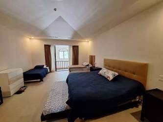 Loft bedroom with large windows, balcony access and en-suite in Bristol Buenaventura Beach Resort Panama