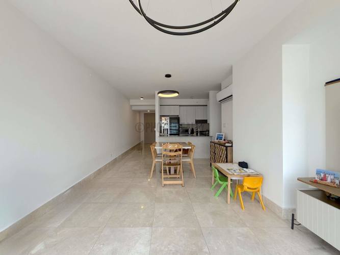 Spacious furnished living room with ocean view windows at PH Waters on the Bay Panama City