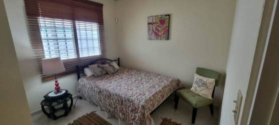 Living area with ceramic tile flooring, natural light window in El Coco Penonomé