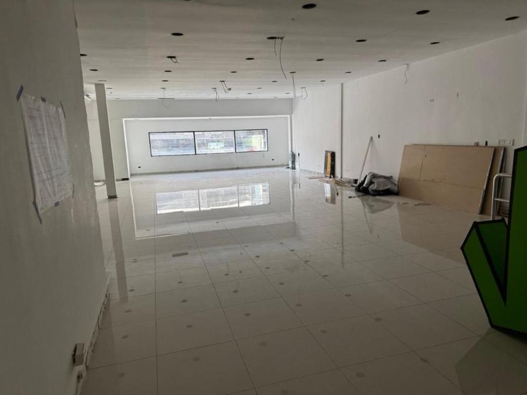 Modern indoor luxury vehicle showroom with garage space at Business Tower Calle 50 Obarrio Panama