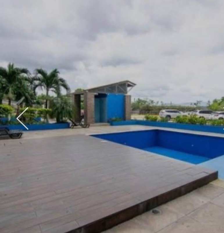 Modern swimming pool and sun deck area with lounge chairs and palm trees PH Mystic Hills El Crisol