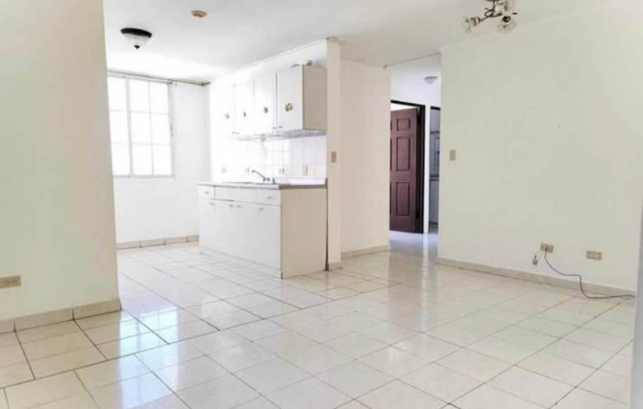 Open kitchen and living space with white cabinets and tiled floor PH Mystic Hills Panama City