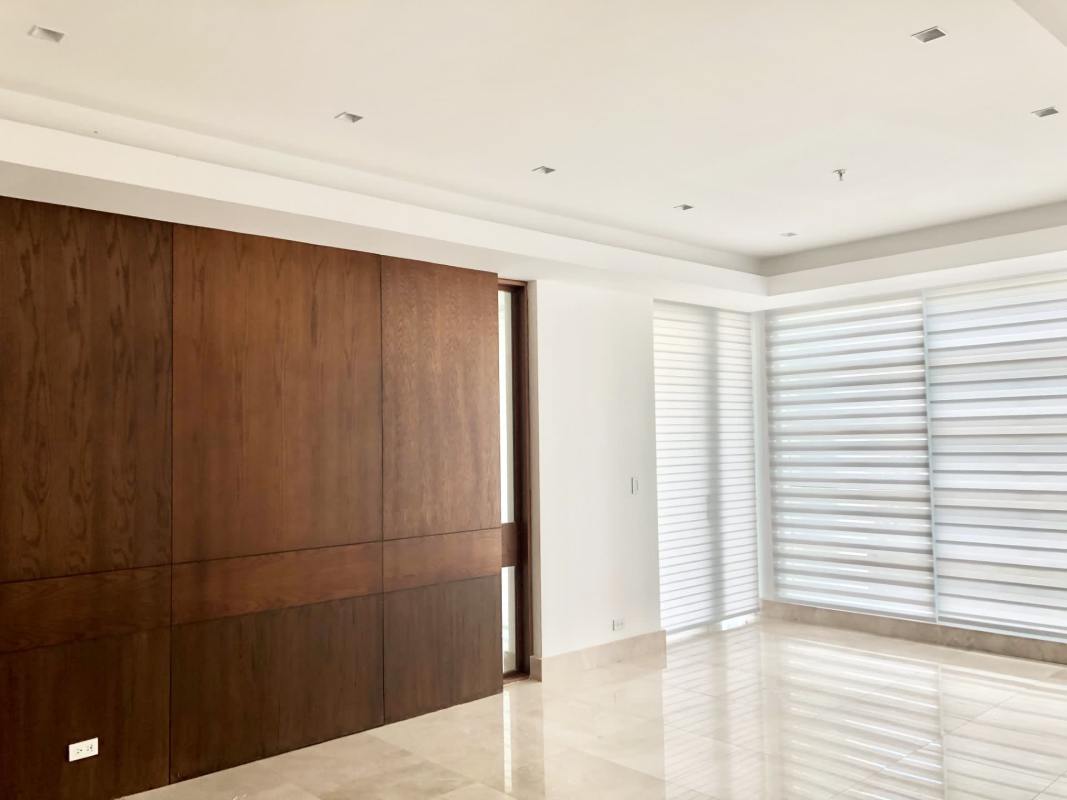 Modern living room with large windows, wood feature wall, marble flooring in PH Paramount Costa del Este