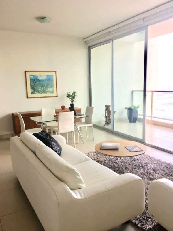 Living room with large windows, ocean views and elegant furnishings in PH Dupont Punta Pacifica