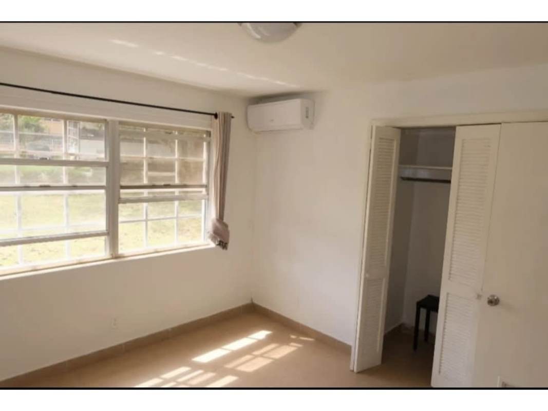 Kitchen with granite counters, wooden cabinets, stainless appliances and ceiling fan in PH Residencial Clayton Panama