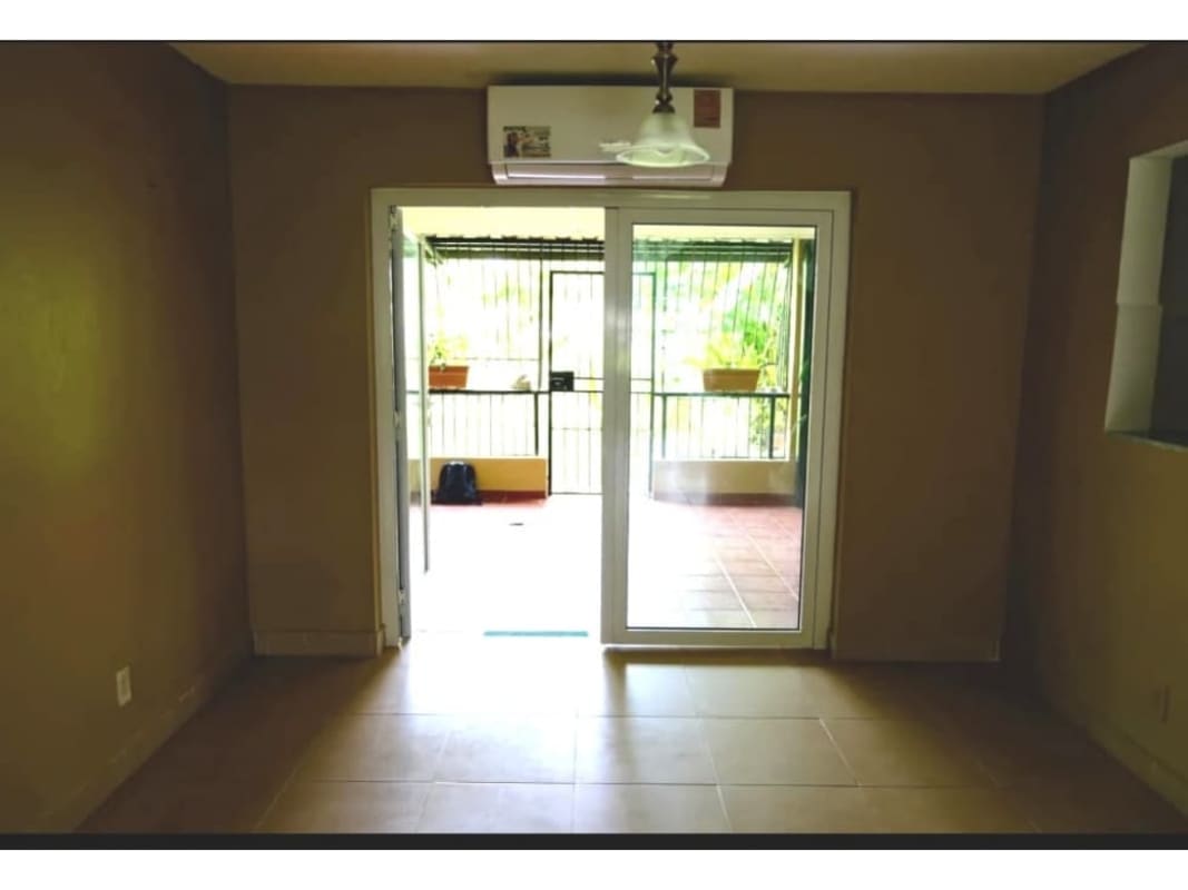 Covered patio outdoor living space with ceiling fan, plants in PH Residencial Clayton Panama