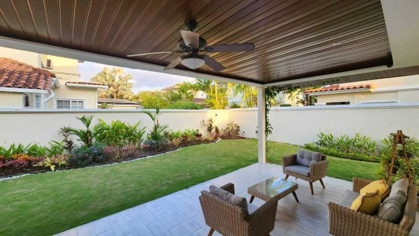 Suburban backyard with covered terrace and garden at Villa Valencia Costa Sur Panama