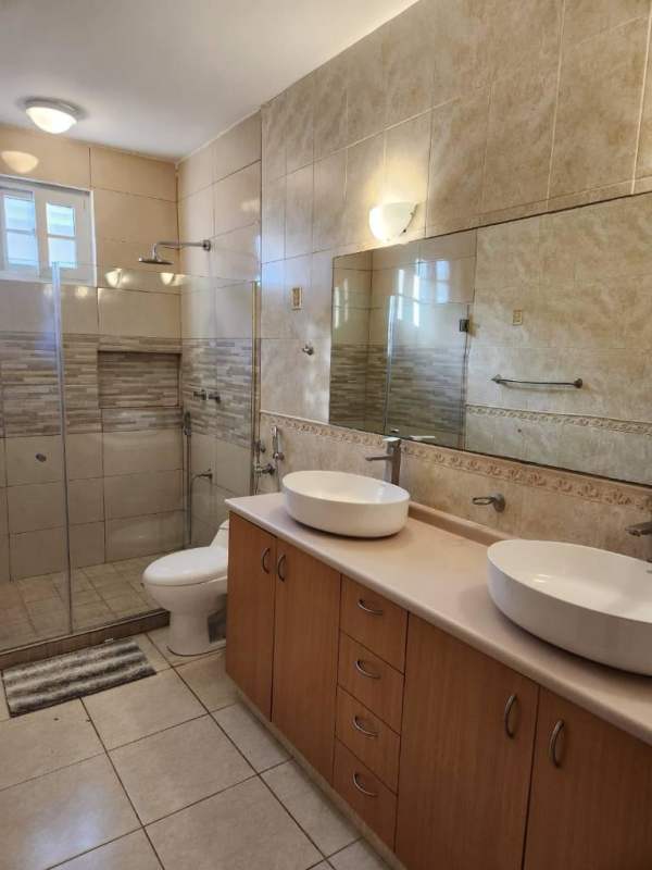 Modern bathroom with vessel sink and walk-in glass shower Costa Sur Panama