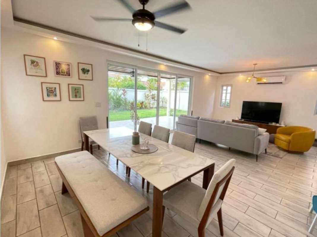 Remodeled kitchen with green cabinets, patterned tiles and open shelving in Villa Valencia Panama