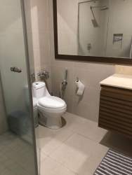 Updated bathroom with glass shower and large mirror condo rental Panama