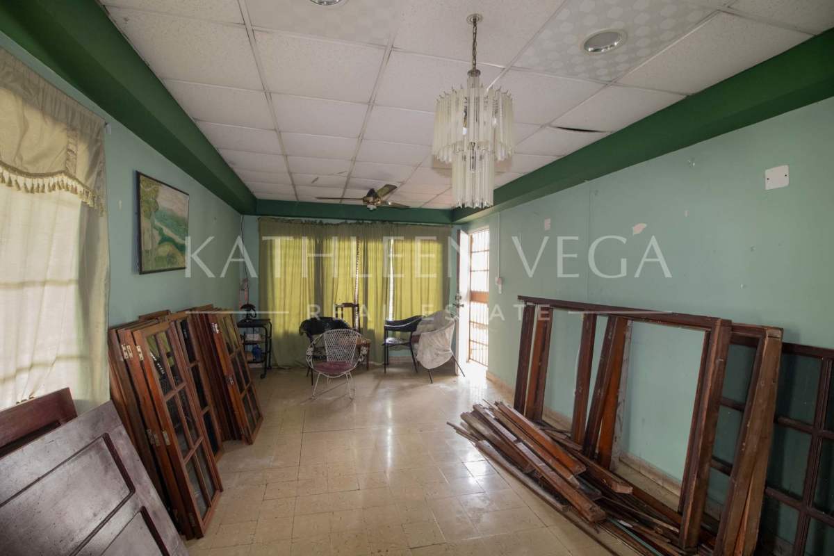Interior enclosed porch with windows and chandelier, space for remodeling in house Carrasquilla Panama