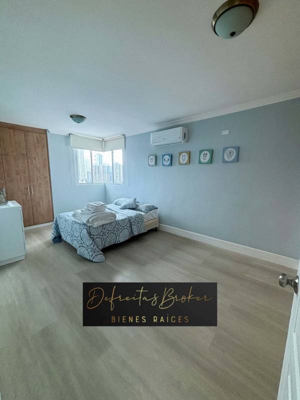 Bedroom featuring built-in closet, AC, large window overlooking Panama skyline at PH Emporium Tower