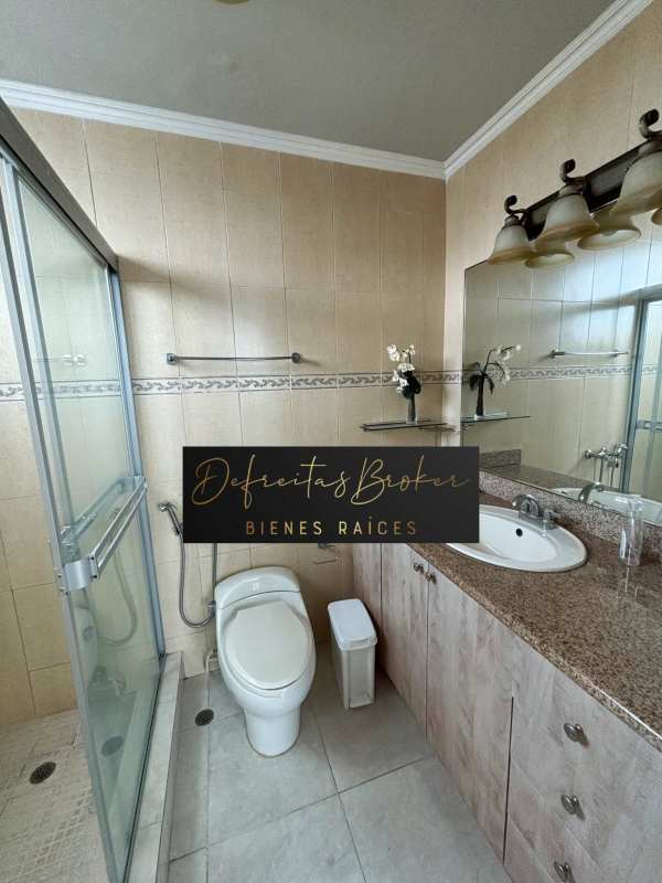 Bedroom with built-in wardrobe floating shelves patterned bedding PH Emporium Tower Panama