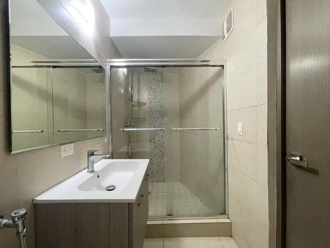 Contemporary bathroom with glass shower enclosure and wall vanity in PH Lumiere Costa del Este Panama