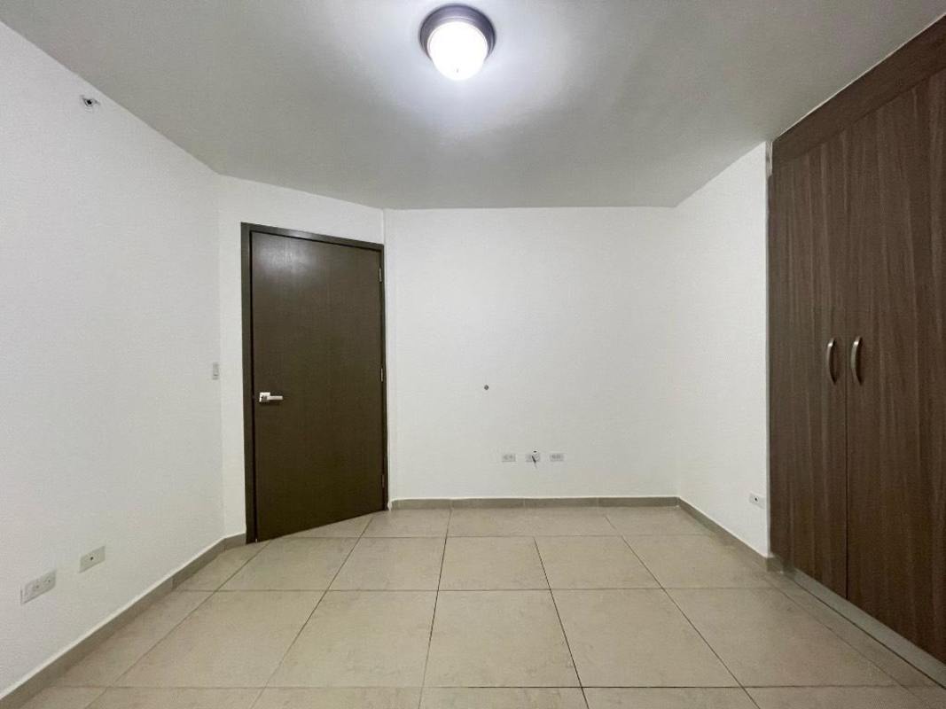 Bedroom with tile floors, built-in closet and panoramic window in PH Lumiere Costa del Este Panama