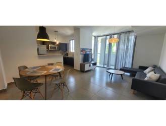 Modern dining area adjacent living room with terrace access in furnished apartment Mosaic Panama