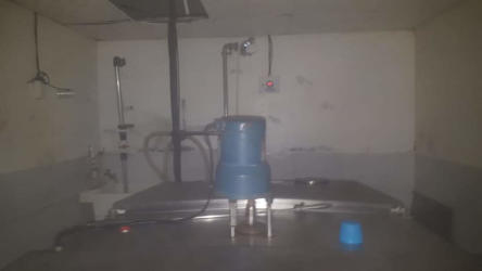 Milking station interior setup including storage tanks and farm utility area ranch Veraguas Panama