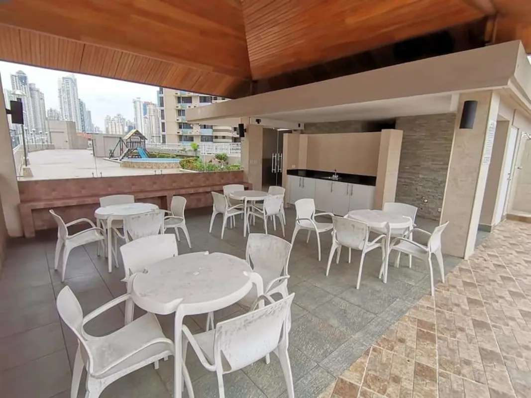 Communal outdoor patio with tables, chef station, city skyline in PH San Francisco Bay Panama