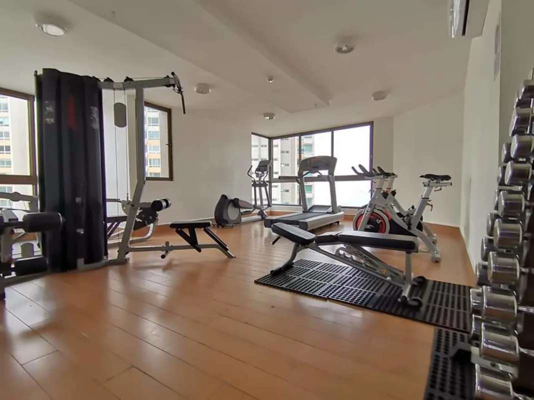Indoor gym with cardio machines and weights at PH San Francisco Bay Panama