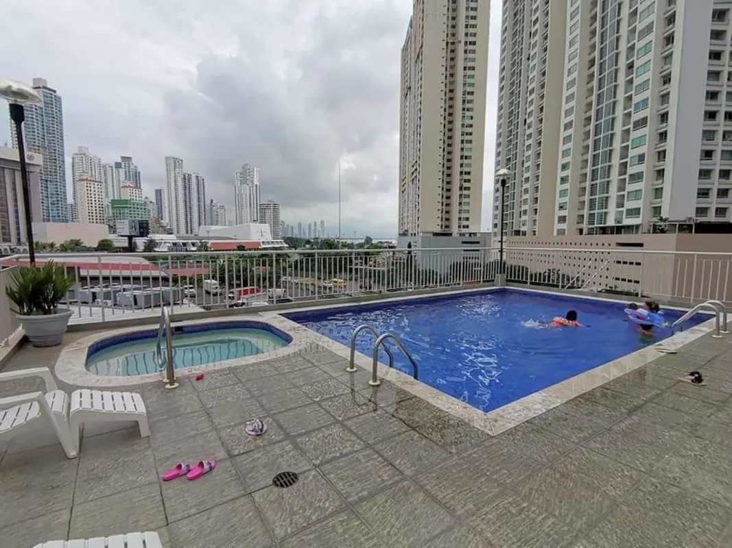 Swimming pool with jacuzzi surrounded by towers skyline in PH San Francisco Bay Panama