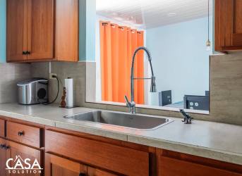 Guesthouse bedroom with colorful decor and kitchenette in Dolega estate Panama