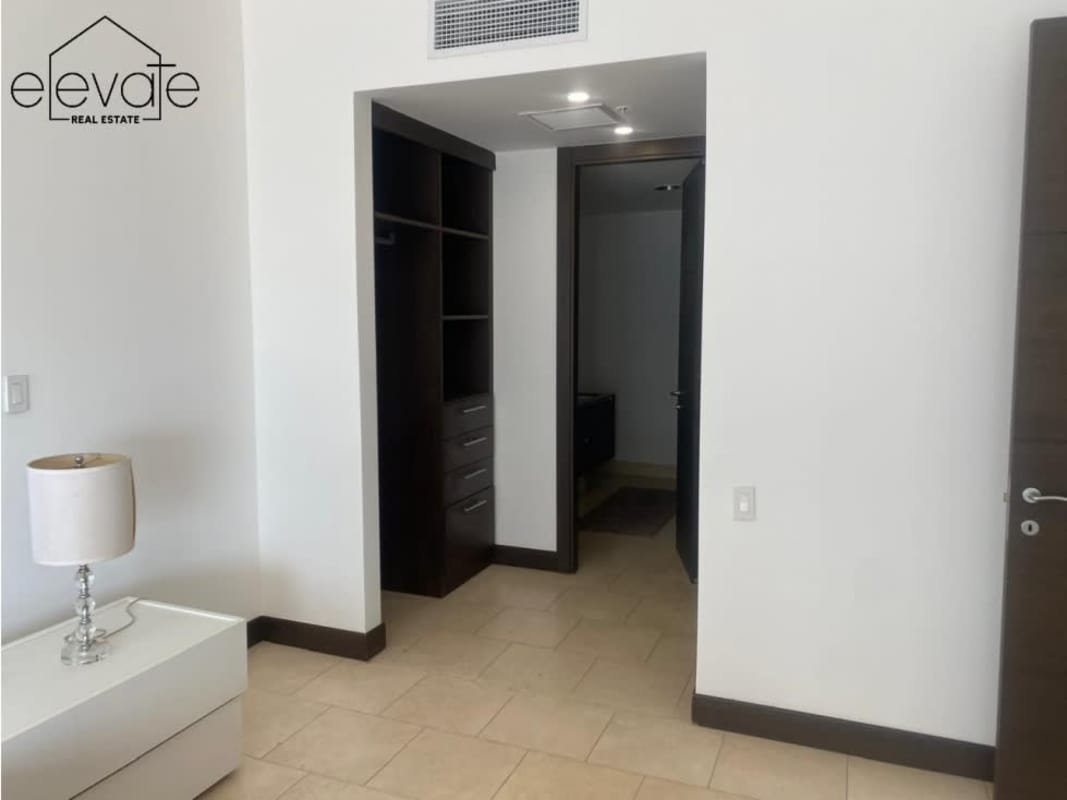 Modern bedroom with tile flooring, walk-in closet, and minimalist design in Ocean Club Punta Pacifica Panama City